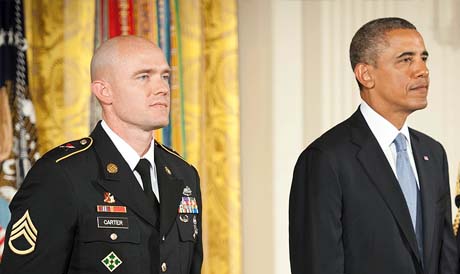 President Barack Obama prepares to bestow the Medal of Honor to U.S. Army Staff Sgt. Ty Michael Carter, left, during a ceremony at the White House in Washington, D.C., Aug. 26, 2013. U.S. Army photo by Staff Sgt. Bernardo Fuller.