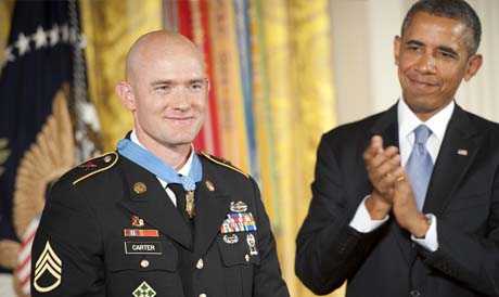 President Barack Obama and the audience applaud U.S. Army Staff Sgt. Ty Michael Carter after presenting Carter with the Medal of Honor during a ceremony at the White House in Washington, D.C., Aug. 26, 2013. U.S. Army photo by Staff Sgt. Bernardo Fuller.