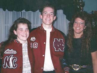 A young Ty Carter and his sister, Amber, try on letterman jackets, a gift from their maternal grandparents, on Christmas day in 1997.
Photo courtesy of the Carter family.