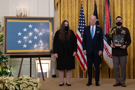 Tamara Cashe, the spouse of U.S. Army Sgt. 1st Class Alwyn C. Cashe, stands as the citation is read before receiving the Medal of Honor from President Joseph R. Biden Jr. during a ceremony at the White House in Washington, D.C., Dec. 16, 2021. Sgt. 1st Class Cashe was posthumously awarded the Medal of Honor for actions of valor during Operation Iraqi Freedom while serving as a platoon sergeant with Alpha Company, 1st Battalion, 15th Infantry Regiment, 3rd Infantry Division, in Salah Ad Din province, Iraq, on Oct. 17, 2005. (U.S. Army photo by Laura Buchta)