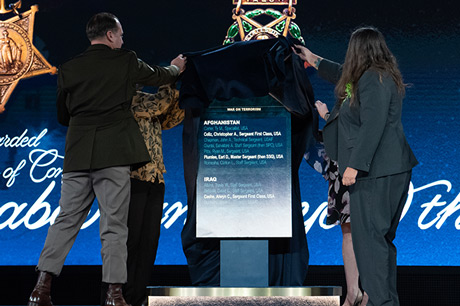 U.S. Army Master Sgt. Earl D. Plumlee; Tamara Cashe, spouse of U.S. Army Sgt. 1st Class Alwyn C. Cashe; Kasinal Cashe White, sister of Sgt. 1st Class Cashe; and Katherine Celiz, spouse of U.S. Army Sgt. 1st Class Christopher A. Celiz, uncover a Hall of Heroes plaque that will be displayed at the Pentagon during a Medal of Honor Induction Ceremony at Joint Base Myer-Henderson Hall, Va., Dec. 17, 2021. The ceremony was held in honor of U.S. Army Sgt. 1st Class Alwyn C. Cashe, Sgt. 1st Class Christopher A. Celiz and Master Sgt. Earl D. Plumlee. (U.S. Army photo by Laura Buchta)