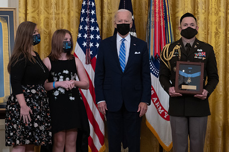 Katherine Celiz, spouse of U.S. Army Sgt. 1st Class Christopher A. Celiz, and their daughter Shannon, stand as the citation is read before receiving the Medal of Honor from President Joseph R. Biden Jr. during a ceremony at the White House in Washington, D.C., Dec. 16, 2021. Sgt. 1st Class Celiz was posthumously awarded the Medal of Honor for actions of valor during Operation Freedom’s Sentinel while serving as a battalion mortar platoon sergeant with Company D, 1st Battalion, 75th Ranger Regiment, in Paktiya province, Afghanistan, on July 12, 2018. (U.S. Army photo by Laura Buchta)