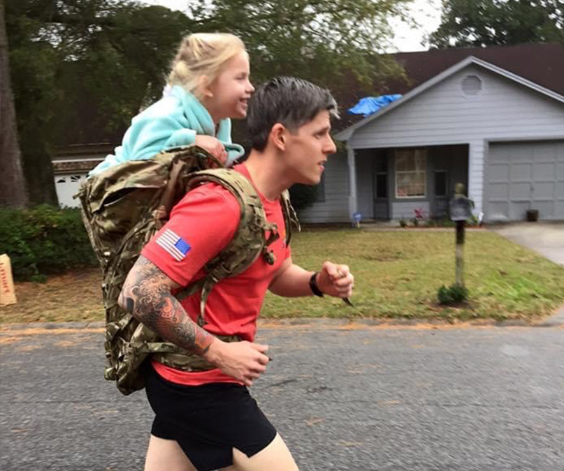 Sgt. 1st Class Christopher Celiz performs physical training carrying his daughter on his back. On this day, they completed over a mile together. (Photo courtesy of Katie Celiz)
