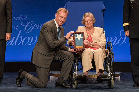 Deputy Secretary of Defense Patrick M. Shanahan presents Pauline Lyda Wells Conner, the spouse of U.S. Army 1st Lt. Garlin M. Conner, the Medal of Honor flag at the Pentagon, in Arlington, Va., June 27, 2018. Conner was posthumously awarded the Medal of Honor, June 26, 2018 for actions while serving as an intelligence officer during World War II on Jan. 24, 1945.  (U.S. Army photo by Spc. Anna Pol)