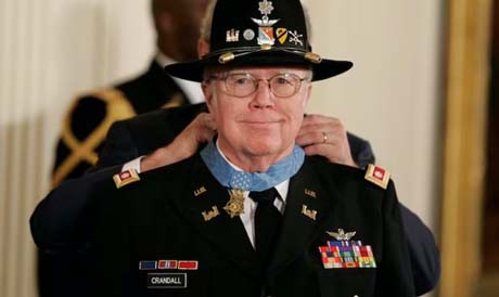 President George W. Bush places the Medal of Honor around the neck of Army pilot Lt. Col. Bruce P. Crandall, who saved the lives of dozens of soldiers during a mission in the Ia Drang Valley of Vietnam in 1965.