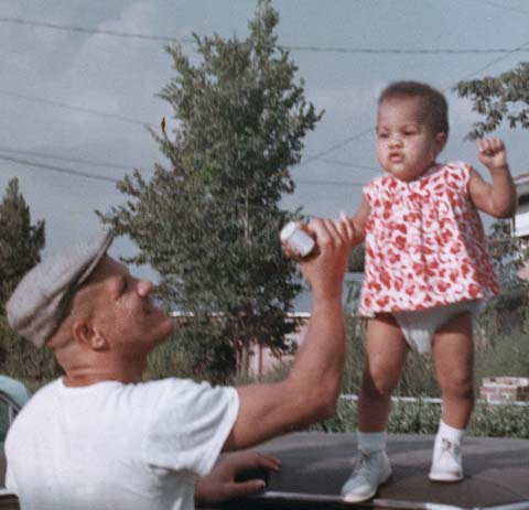 Paris Davis plays with his daughter at their home, circa early 1970s. (Photo courtesy of the Davis Family)