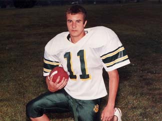 Salvatore Giunta posing in his high-school footbal uniform.