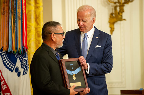 Mr. John Kaneshiro, the son of former U.S. Army Staff Sgt. Edward Kaneshiro, receives the Medal of
Honor from the president Joseph R. Biden in the East Room at the White House in Washington, D.C., July
5, 2022. Mr. Kaneshiro is receiving the award on behalf of his father’s acts of gallantry and intrepidity
above and beyond the call of duty while serving as an Infantry Squad Leader with Troop C, 1st Squadron,
9th Cavalry, 1st Cavalry Division near Phu Huu 2, Kim Son Valley, Republic of Vietnam. On July 25, 1963,
Kaneshiro was awarded the Distinguished Service Cross for his actions. On July 21, 2020, the Secretary of
the Army recommended the upgrade of his award to the Medal of Honor. (U.S. Army photo by Sgt.
Henry Villarama)