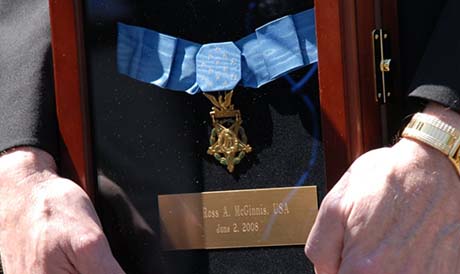 Parents of posthumous Medal of Honor recipient Spc. Ross McGinnis take a moment to reflect about their son following a White House ceremony as they hold the framed medal. McGinnis received the nations highest military honor after sacrificing himself to save his fellow Soldiers. (Photo Credit: U.S. Army)