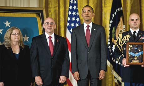 President Barack Obama presents the Medal of Honor posthumously to Phil and Maureen Miller, the parents of U.S. Army Staff Sgt. Robert J. Miller, during a ceremony in the East Room of the White House in Washington, D.C., Oct. 6, 2010. Miller received the honor for his heroic actions on Jan. 25, 2008, in Afghanistan where he sacrificed his life to save the lives of his teammates and 15 Afghanistan soldiers. (U.S. Army photo by D. Myles Cullen)