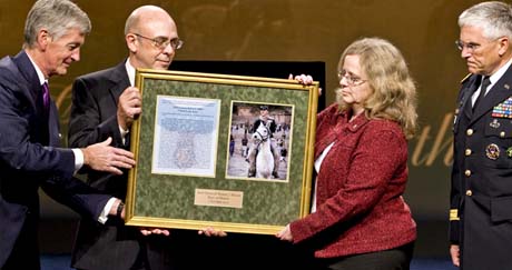 Army Secretary John M. McHugh presents a plaque to Phil and Maureen Miller, the parents of Medal of Honor recipient, Staff Sgt. Robert J. Miller, as Army Chief of Staff Gen. George W. Casey Jr. looks on during a ceremony at the Pentagon, Oct. 7, 2010. (Photo Credit: Department of Defense)