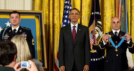 President Barack Obama stands at attention prior to presenting the Medal of Honor to Army Sgt. 1st Class Leroy Petry at the White House in Washington, D.C., July 12, 2011.