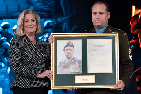 Secretary of the U.S. Army Christine E. Wormuth presents the Medal of Honor plaque to U.S. Army Master Sgt. Earl D. Plumlee during a Medal of Honor Induction Ceremony at Joint Base Myer-Henderson Hall, Va., Dec. 17, 2021. Master Sgt. Plumlee was awarded the Medal of Honor for actions of valor during Operation Enduring Freedom while serving as a weapon’s sergeant with Charlie Company, 4th Battalion, 1st Special Forces Group (Airborne), near Ghazni, Afghanistan, Aug. 28, 2013. (U.S. Army photo by Laura Buchta)