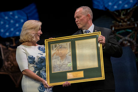 Secretary of the Army Christine Wormuth presents a photo and citation to retired Army Lt. Col. John D. Lock, accepting on behalf of Medal of Honor recipient Army 1st Lt. Ralph Puckett, Jr., in a ceremony in which Puckett and five other Medal of Honor recipients were inducted into the Pentagon Hall of Heroes, at Joint Base Myer-Henderson Hall, Va., July 6, 2022. (DoD photo by Lisa Ferdinando) 
