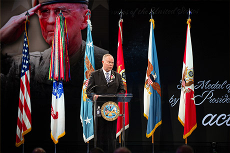 Retired Lt. Col. John Lock delivers remarks on behalf of Medal of Honor recipient retired Col. Ralph Puckett during induction ceremony to the Pentagon’s Hall of Heroes at Conmy Hall, Joint Base Myer-Henderson Hall in Arlington, Virginia, July 6, 2022. (U.S. Army photo by Sgt. Henry Villarama)