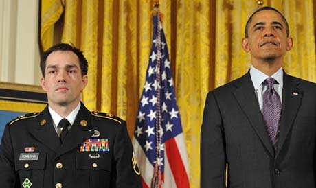 President Barack Obama stands with Medal of Honor recipient former Army Staff Sgt. Clinton Romesha as the citation is read during a ceremony in the East Room at the White House in Washington on February 11, 2013. Romesha is receiving the medal for his courageous actions while defending a combat outpost in Afghanistan in 2009. (Photo Credit: U.S. Army)