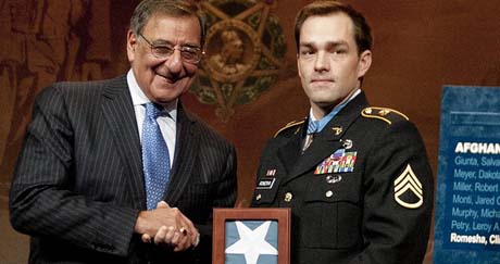 Secretary of Defense Leon E. Panetta presented former Staff Sgt. Clinton Romesha with a Medal of Honor flag during the Hall of Heroes Induction Ceremony (Photo Credit: U.S. Army)