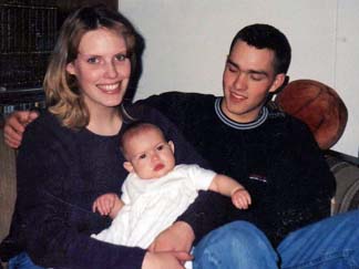 New parents Tammy and Clint Romesha hold their daughter, Dessi, in December of 2001.