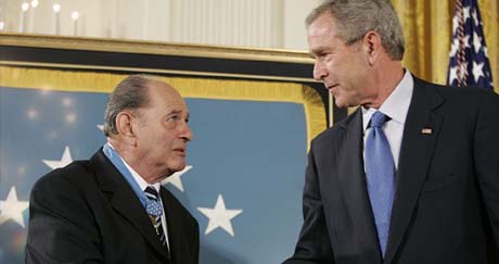 Rubin shakes hands with President George W. Bush, September 2005. White House photo by Paul Morse.