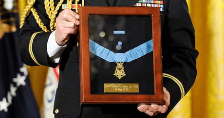 An Army officer holds the Medal of Honor during a White House ceremony that posthumously honored Spc. Leslie H. Sabo Jr. In 1970, Sabo died while saving the lives of his fellow soldiers during a secret mission in Cambodia.