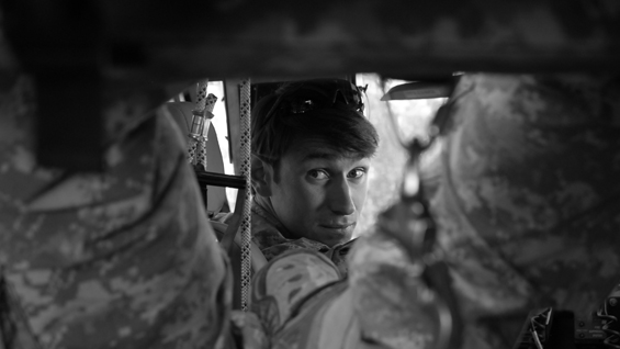 Capt. William Swenson sits in Task Force Chosin mine-resistant, ambush-protected vehicle while conducting a shura, October 2009.