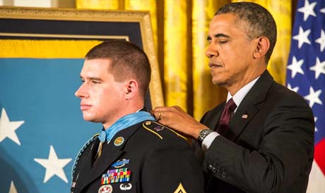 President Barack Obama drapes the Medal of Honor around the neck of former Army Sgt. Kyle J. White at the White House, Washington, May 13, 2014. White is being awarded the Medal of Honor for his actions while on a dismounted movement in the mountainous terrain in Aranas, Afghanistan, Nov. 9, 2007. (U.S. Army Photo by Sgt. Mikki L. Sprenkle/Released)