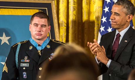 Former Army Sgt. Kyle J. White is applauded by President Barack Obama and those in attendance of the Medal of Honor ceremony at the White House, Washington, May 13, 2014. White was awarded the Medal of Honor for his actions while on a dismounted movement in the mountainous terrain in Aranas, Afghanistan. (U.S. Army Photo by Sgt. Mikki L. Sprenkle/Released)