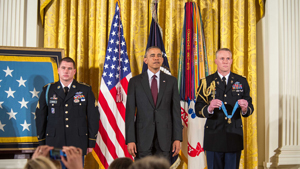 Former Army Sgt. Kyle J. White and President Barack Obama listen to the reading of the citation during a Medal of Honor ceremony at the White House, Washington. White is being awarded the Medal of Honor for his actions while on a dismounted movement ...
