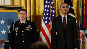 President Barack Obama and former Sgt. Kyle White listen to the reading of the Medal of Honor citation at the White House, May 13, 2014.  White was recognized for his actions during his deployment to Afghanistan in 2007 while serving with Chosen Comp...