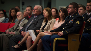 Former Sgt. Kyle White, the most recent Medal of Honor recipient, listens during the ceremony to induct him into the Hall of Heroes at the Pentagon, May 14, 2014, as his girlfriend, Helen Ball, looks at him. President Barack Obama awarded White the m...