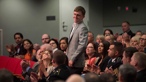 Mr. Kain Schilling, stands to be recognized during a ceremony to induct Sgt. Kyle White into the Medal of Honor Hall of Heroes at the Pentagon May 14, 2014. Schilling was an Army specialist and Whites forward observer during the firefight when White ...