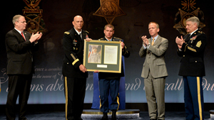 The Chief of Staff of the Army Gen. Raymond T. Odierno presents a photo and citation to Medal of Honor recipient former Sgt. Kyle White as the Deputy Secretary of Defense Robert O. Work, the Under Secretary of the Army Brad R. Carson, and Sgt. Maj. o...