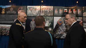Sgt. Kyle White tells Deputy Secretary of Defense Robert Work and Gen. Raymond Odierno, the Army Chief of Staff, about some of the photos of him on the wall outside the Pentagon Auditorium, May 14, 2014. Secretary Work presided over a ceremony to ind...