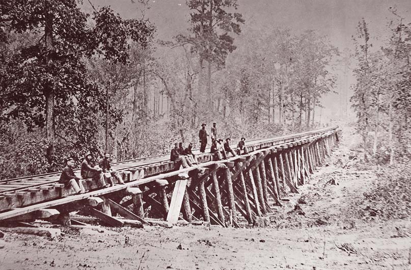 Railroads were vital to the armies of the American Civil War because they allowed for the quick and efficient transportation of troops, supplies, and wounded soldiers over long distances. Depriving the enemy of this critical infrastructure was part of the Union Army's strategy to bring the war to an end. Image: Photograph of a military railroad bridge circa 1861 - 1865,  U.S. Military Railroad at City Point - by Andrew J. Russell and Mathew Benjamin Brady. Photo courtesy of Metropolitan Museum of Art.