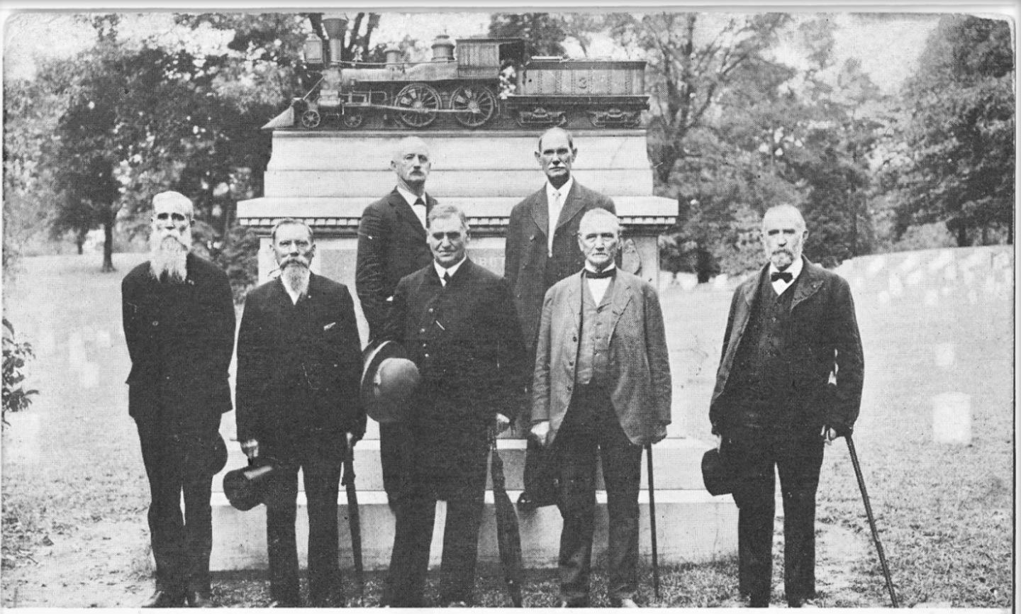 Postcard image of surviving Andrews Raiders, 1908 posing in front of Ohio monument erected to the men and their feat. Daniel A. Dorsey, Jacob Parrott, W.J. Knight, Wm. Bensinger, Jno. A. Wilson, W.W. Brown. Photograph taken by L. Engel. 