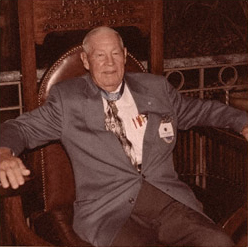 Older Ernest Childers relaxing in a large chair