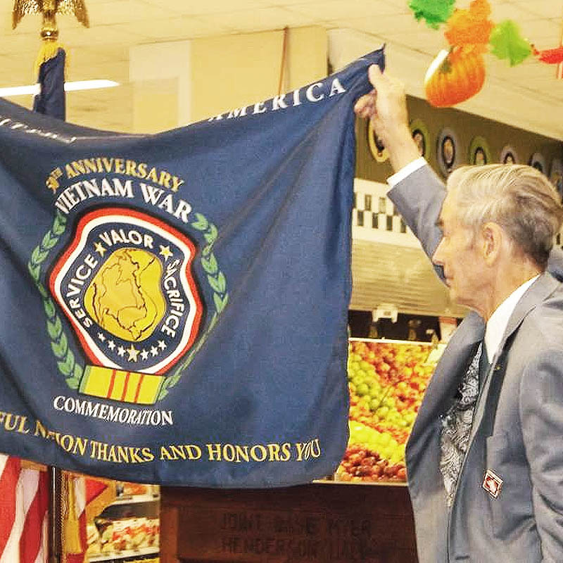 Image showing person hanging Commemoration Flag