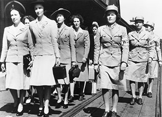 Women from the Women Army Auxialiary Corps, or WAAC, marching.