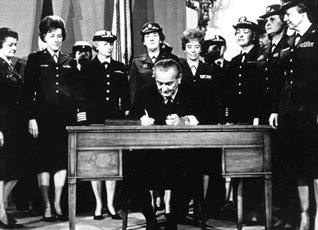President Lyndon B. Johnson signs Public Law 90-130, allowing military women to serve in Army National Guard