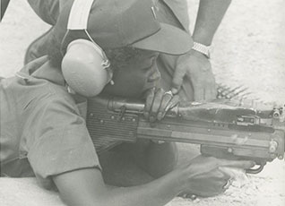 A WAC firing an M60 machine gun in Army qualifications test.