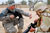 United States Soldier shows Iraq soldier how to lock his bolt to the rear when loading a magazine