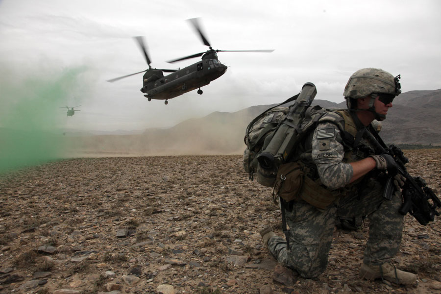 Soldier provides security before boarding a CH-47 Chinook helicopter
