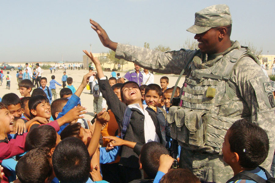 Soldier plays 'High-Five' with children at Northern Afghanistan border town of Hairatan