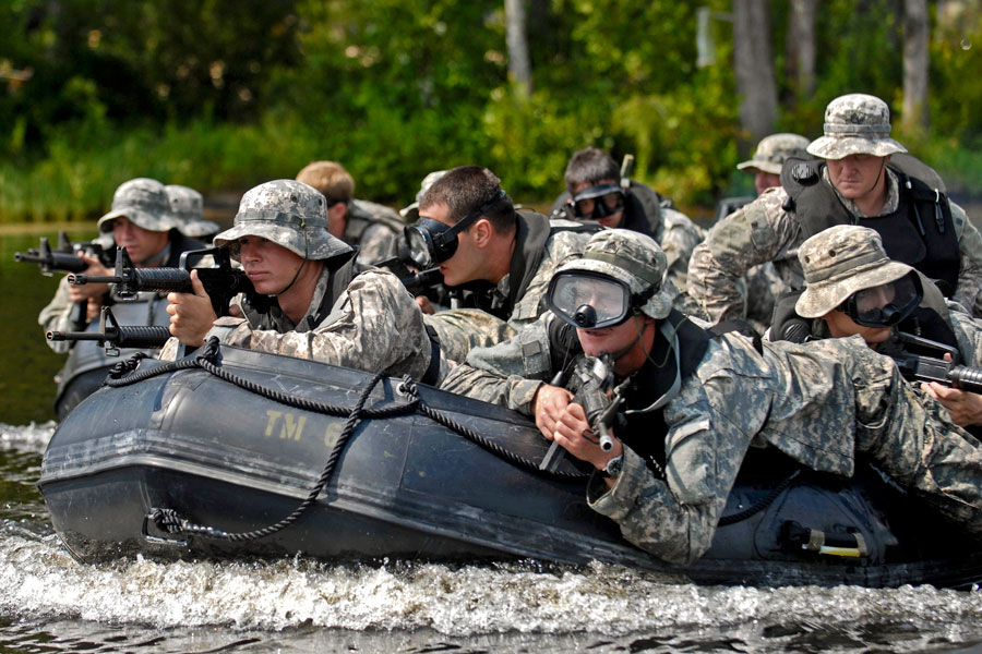 Soldiers on raft prepare to storm beach at Mott Lake