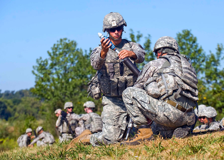 Soldiers prepares 60mm mortar to launch at fixed targets
