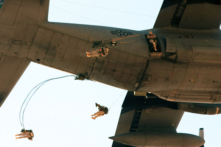 Paratroopers jump from C-130 aircraft