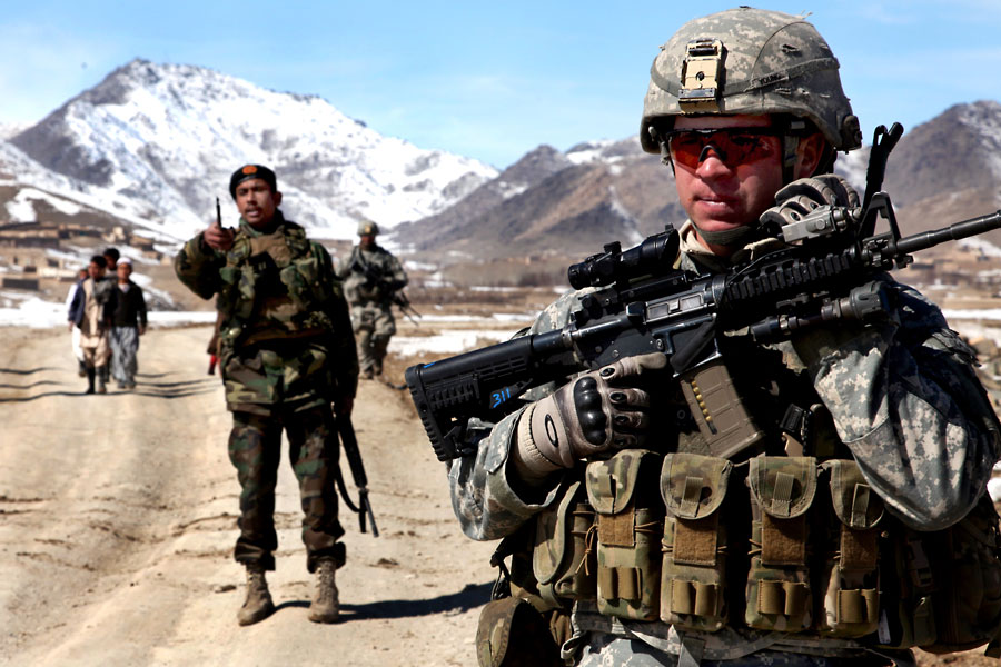 Armed Soldiers from A Company, 1-503rd Battalion, 173rd Airborne Brigade Combat Team, conduct patrol
