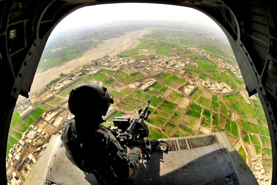 Aerial gunner provides aerial security from CH-47 Chinook helicopter above Khost Province, Afghanistan