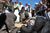 A Soldier takes a break to arm wrestle an Afghan man