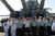 Soldiers, Sailors, Airmen and Marines raise their right hands as they recite the oath of enlistment on the EX-USS Missouri